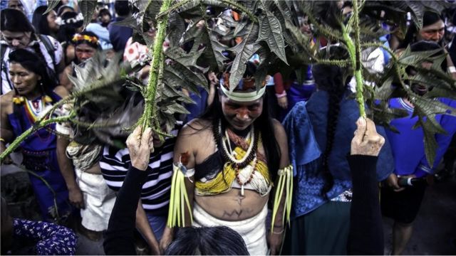 A woman is purified with nettles before a ceremony in Puyo, Ecuador.