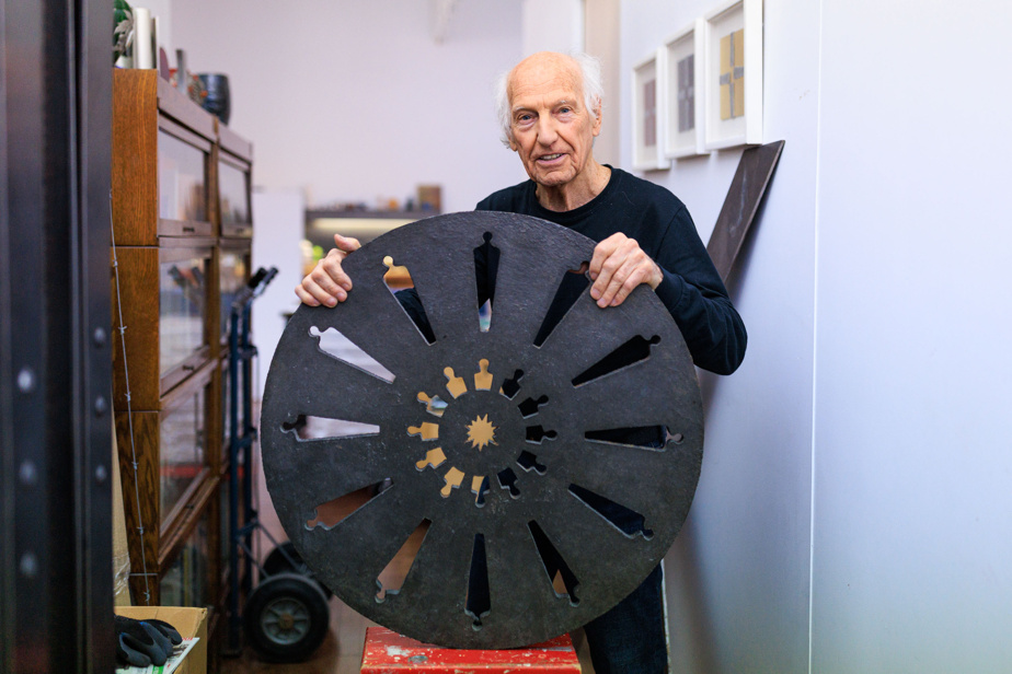 André Fournelle and his cast iron manhole evoking the rose window of the cathedral of Bourges, in France, part of the installation Sous les pavés