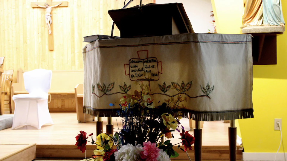 The interior of a church with a close-up of a lectern on which is placed an embroidered doily.