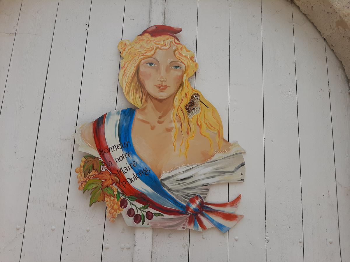 A Marianne in honor of Pierre Dulong is painted on his garage door.