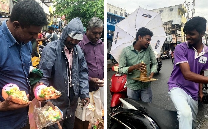 a man negotiates statuettes of Ganesh, another takes it away on a scooter