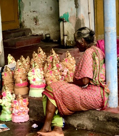 An old lady selling her statuettes of Ganesh