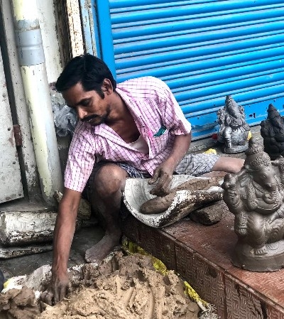 a potter making statuettes of Ganesh