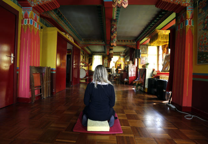 A woman meditates inside a room at the Kagyu-Dzong Tibetan Buddhist Center near the Great Pagoda in the Bois de Vincennes in Paris on May 29, 2015.