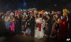 The festivities for the Day of the Dead in Mexico and other Latin American countries include various manifestations that express religious and cultural syncretism.  (AP Photo)