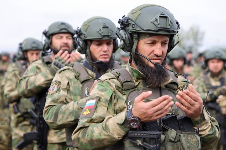 Chechen soldiers in prayer before their departure for Ukraine, October 15, 2022 in the military base of Khankala, Chechnya.  (YELENA AFONINA / TASS / SIPA VIA AFP)