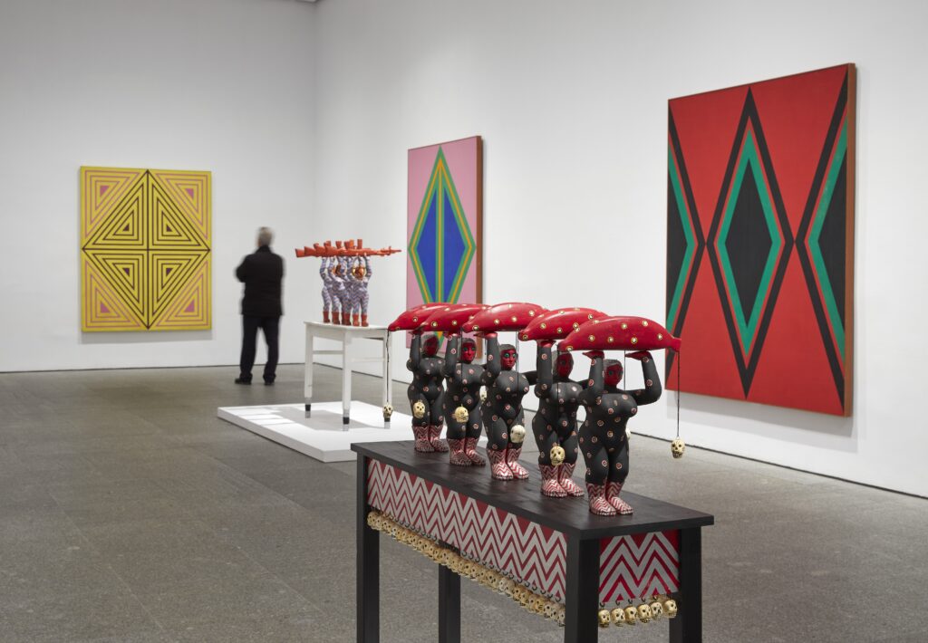 View of the exhibition "Daisy Rita Rica Dynamite".  Reina Sofia Museum.  In the foreground, The red banana carriers, 1971-1974 