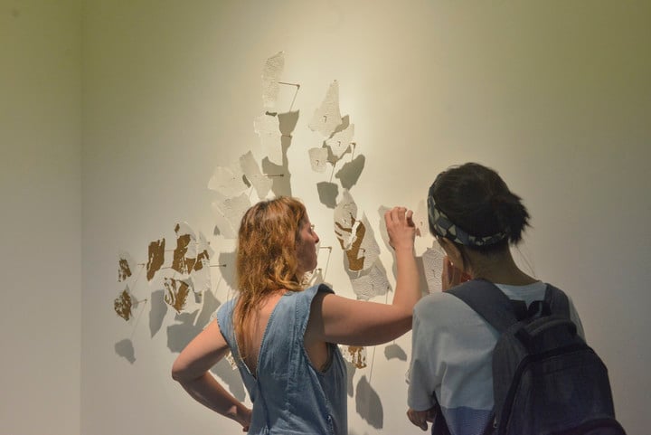 Johanna Wilhem finishes making her fragmented work on openwork paper.  Photo Constance Niscovolos