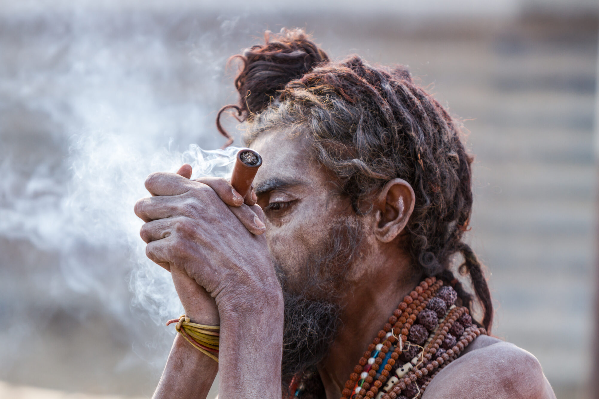 A guru is smoking a cilum of cannabis