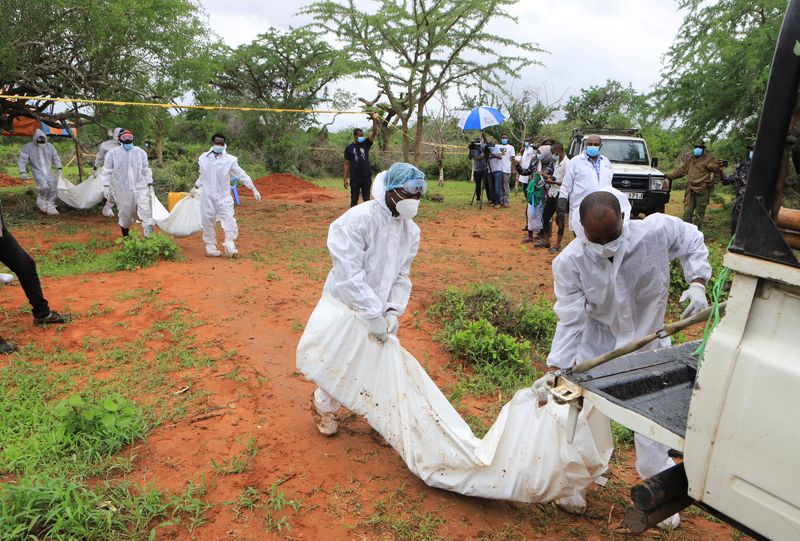 Forensic experts and homicide detectives transport the bodies of suspected members of a Christian sect called the International Church of Good News, who believed they would go to heaven if they starved to death, after their remains were exhumed from their graves in the Shakahola forest. Kilifi County, Kenya.  April 22, 2023. REUTERS/Contributor