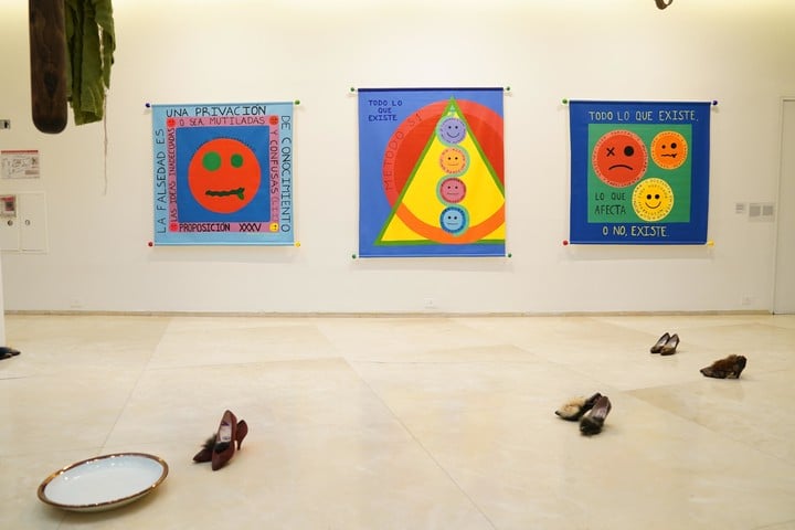 Shoes, installation by Ana Vogelfang.  On the wall, paintings by Belén Romero Gunset.  Photo Juano Tesone